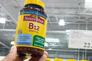 b12 vitamins hand held near sale sign at costco