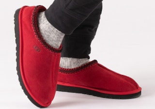a person wearing red ugg tasman slippers