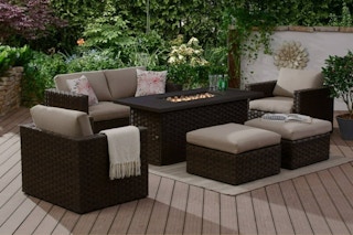 lifestyle image of a fire pit dining table with patio furniture
