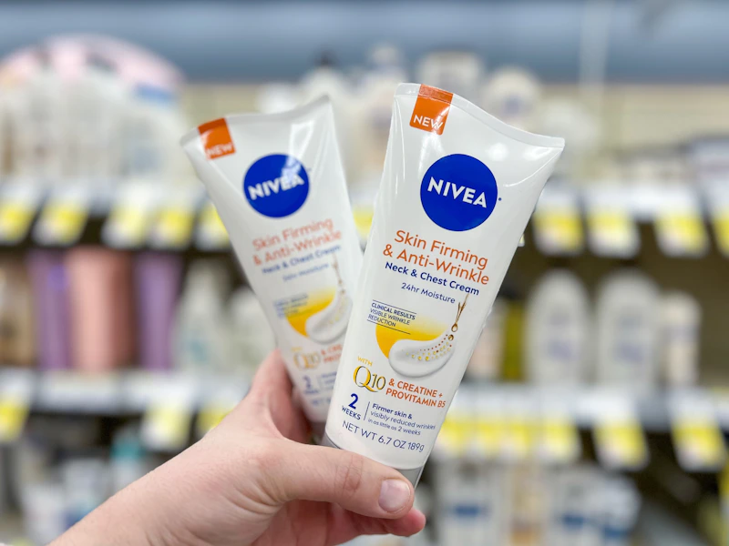 hand holding two tubes of firming cream
