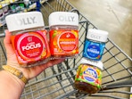 hand holding Olly Focus and Probiotic+Prebiotic contains in front of the Stress and Kids' Multi bottles