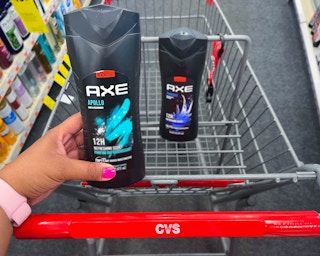 hand holding one bottle of Axe body wash in front of a second bottle inside shopping cart