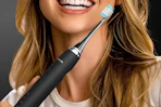 a person holding an electric toothbrush