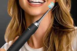 a person holding an electric toothbrush