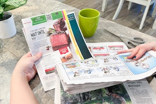 a person pulling a SmartSource coupon insert out of newspaper