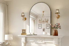 arched wall mirror on top of a fireplace in a living room
