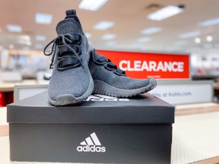 adidas shoes in front of clearance sign