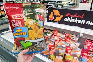 hand holding a bag of tyson fun nuggets in front of signage at target