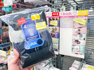 hand holding a hanes kids t-shirt pack in front of clearance underwear