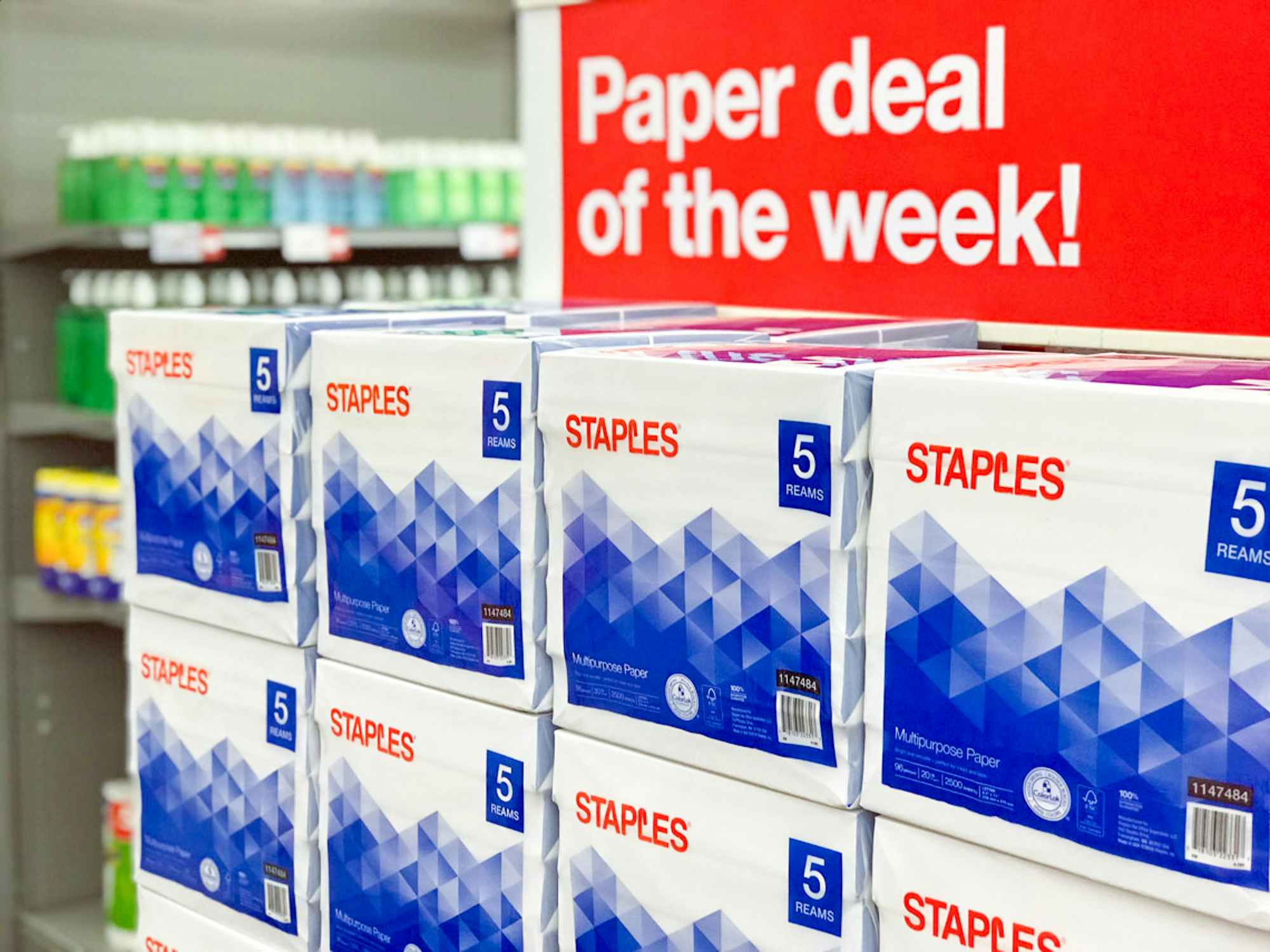 Reams of paper stocked at Staples with a sign that reads "Paper deal of the week"