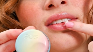 a person putting lip balm on their lips