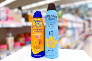 two cans of sunscreen spray on store beauty counter
