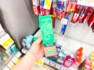 hand holding hello toothpaste in walgreens