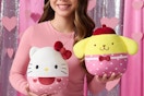 a girl holding sanrio squishmallows