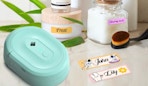 a teal label maker next to labels and jars 
