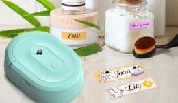 a teal label maker next to labels and jars 