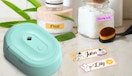 a teal label maker next to labels and jars