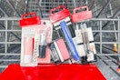 covergirl lip balm, lipstick, blush, mascara, and eyeliner in a cart