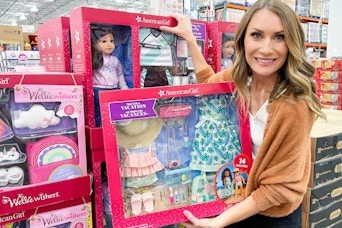 heather holding an american girl doll set