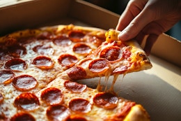 a hand grabbing a pepperoni pizza out of a pizza hut box