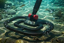 someone using a metal detector underwater
