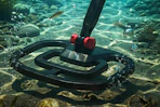 someone using a metal detector underwater