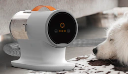 a dog vacuum grooming kit next to a dog