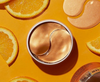Peter Thomas Roth Hydra-Gel Eye Patches on a orange background with orange slices