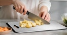 a persoon chopping on a titanium cutting board