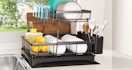 a dish rack with dishes on a counter near a sink