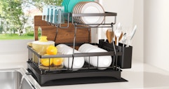 a dish rack with dishes on a counter near a sink