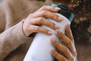 a woman holding a contigo mug
