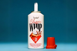 Vacation Classic Whip SPF 30 Sunscreen Mousse on a blue background