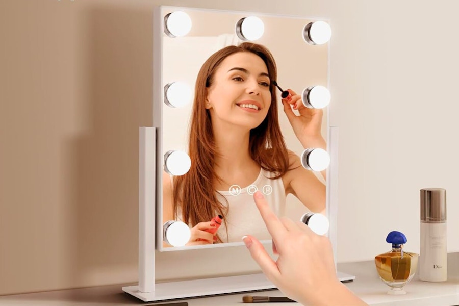 a woman using a vanity mirror