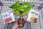 maple syrup, pancake mix, granola bars, and grapes in a cart