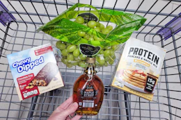 maple syrup, pancake mix, granola bars, and grapes in a cart