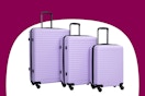 Stock image of a purple luggage set from the brand Travelhouse