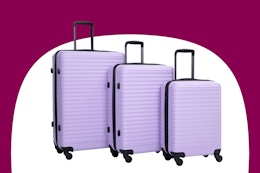 Stock image of a purple luggage set from the brand Travelhouse