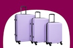 Stock image of a purple luggage set from the brand Travelhouse