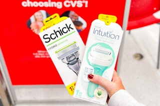 person holding 2 schick razors