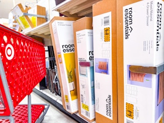 dressers sitting on a shelf with a target cart parked in front