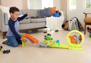 child playing with the Hot Wheels monster truck track