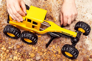 a child playing with a tonka truck