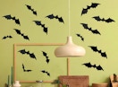 paper bats on a green wall in a room
