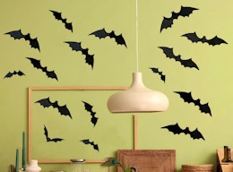 paper bats on a green wall in a room