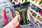 person holding a bag of pistachios