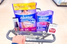 hand pushing walgreens cart with olay and always products
