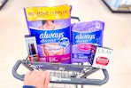 hand pushing walgreens cart with olay and always products