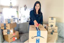 a woman opening amazon boxes