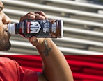 a person drinking a protein drink